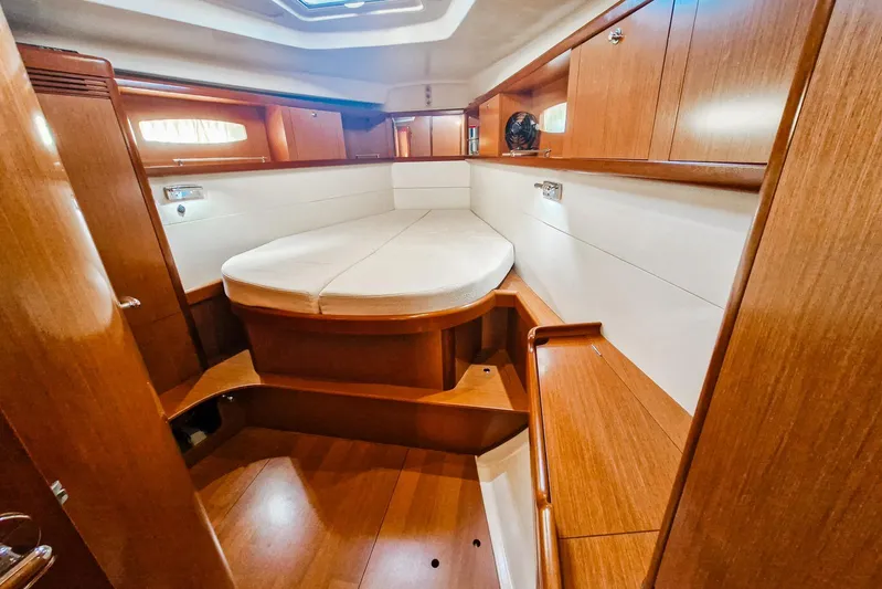  Yacht Photos Pics 2007 Beneteau 46 yacht interior with wooden cabinetry and cozy sleeping area.