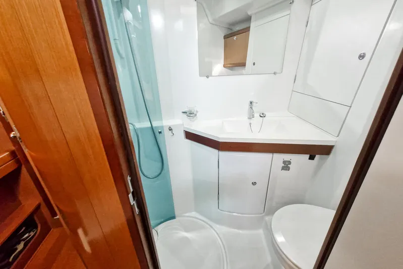  Yacht Photos Pics 2007 Beneteau 46 yacht bathroom with modern fixtures and wooden accents.