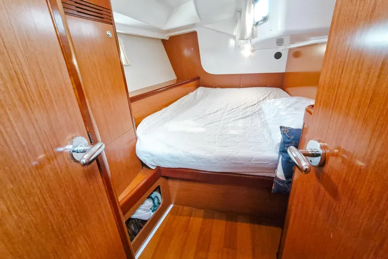  Yacht Photos Pics Cozy cabin interior of 2007 Beneteau 46 yacht with wooden finish and comfortable bed.