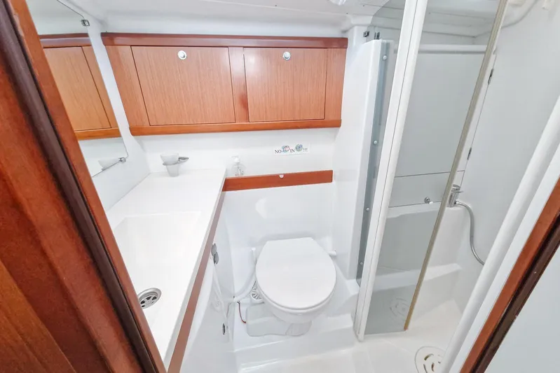  Yacht Photos Pics Luxurious bathroom in 2007 Beneteau 46 yacht with wooden cabinets and modern fixtures.