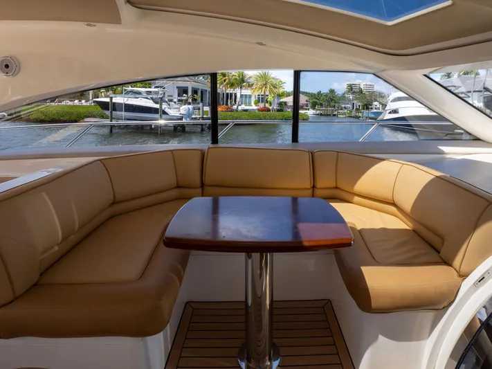 Road Runner Yacht Photos Pics Luxurious interior of 2008 Princess V53 yacht with tan seating and wooden table.