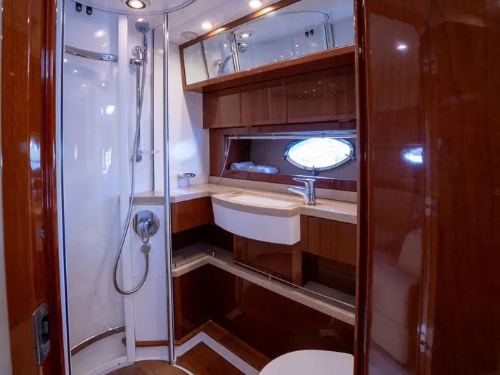 Road Runner Yacht Photos Pics Luxurious bathroom in 2008 Princess V53 yacht with wood accents and modern fixtures.