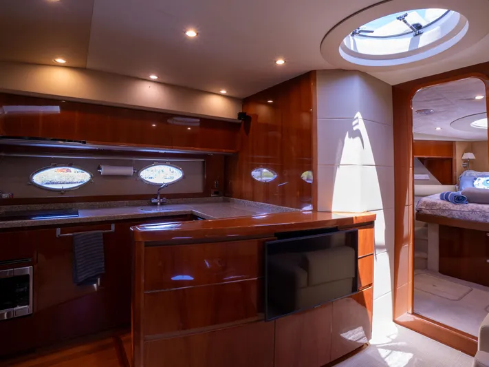 Road Runner Yacht Photos Pics Luxurious interior of 2008 Princess V53 yacht with modern kitchen and cozy bedroom.