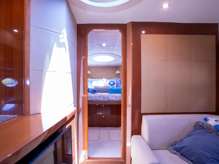 Road Runner Yacht Photos Pics Luxurious interior of 2008 Princess V53 yacht, featuring cozy cabin and elegant wood finishes.