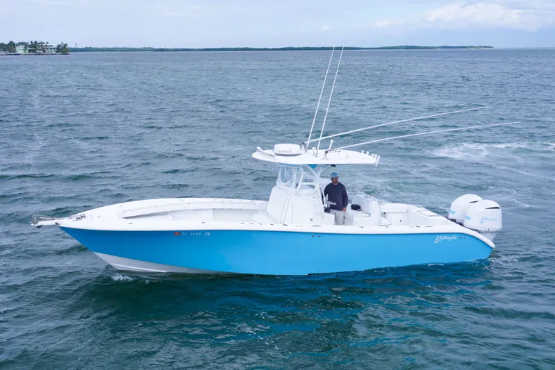  Yacht Photos Pics 2011 Yellowfin 32 Offshore boat on open water, featuring a sleek blue hull.
