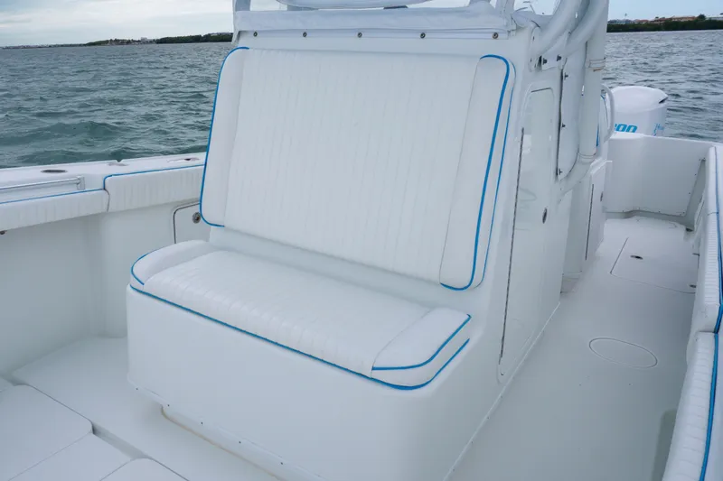  Yacht Photos Pics 2011 Yellowfin 32 Offshore boat interior with white seating and blue trim on the water.