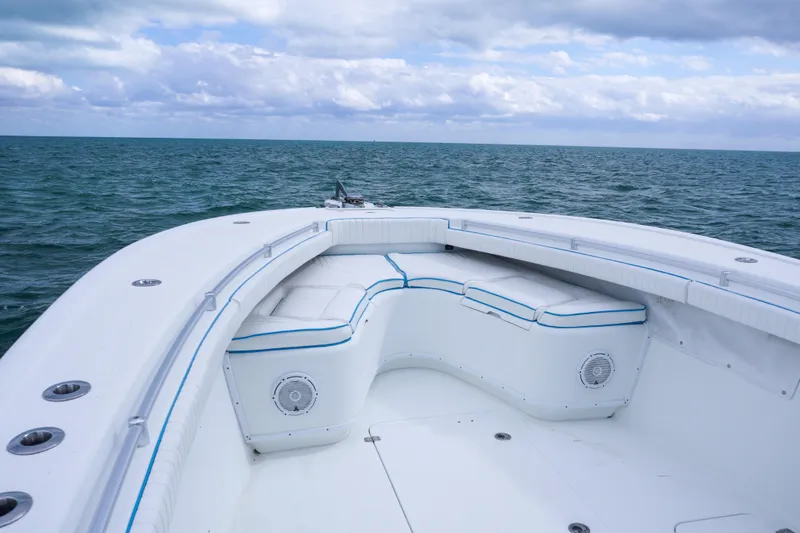  Yacht Photos Pics 2011 Yellowfin 32 Offshore boat interior with ocean view, featuring cushioned seating.