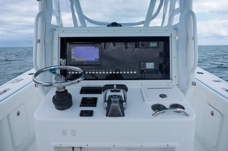  Yacht Photos Pics 2011 Yellowfin 32 Offshore boat console with navigation equipment and steering wheel.