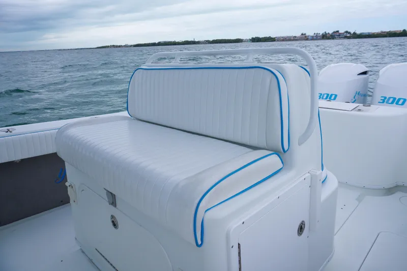  Yacht Photos Pics 2011 Yellowfin 32 Offshore boat with white seating and blue trim on open water.