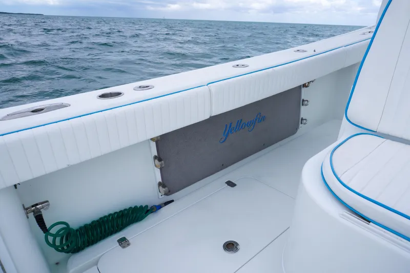 Yacht Photos Pics 2011 Yellowfin 32 Offshore boat interior with ocean view, featuring white seating and blue accents.