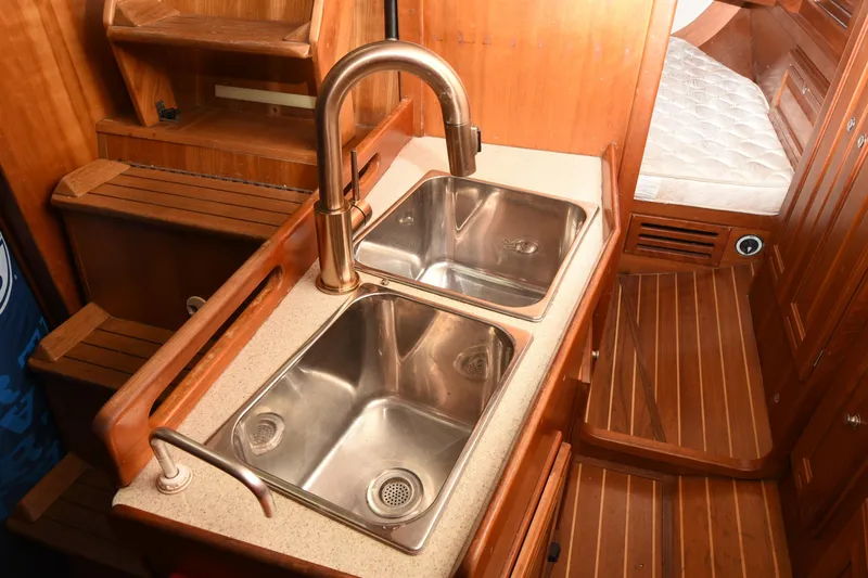Makasi Yacht Photos Pics Wooden interior of 2008 Tartan 4100 yacht with dual stainless steel sinks.