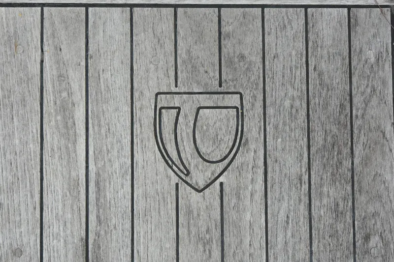 Makasi Yacht Photos Pics Wooden deck with Tartan 4100 logo, 2008 model, featuring vertical planks and emblem.