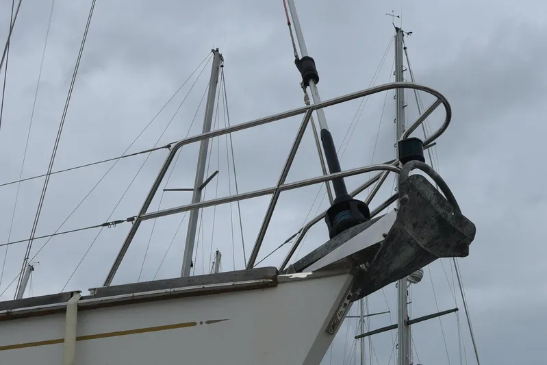 Makasi Yacht Photos Pics Sailboat bow with anchor, Tartan 4100, 2008 model, against cloudy sky.