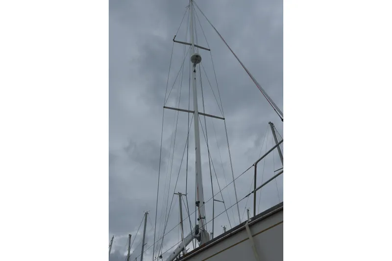 Makasi Yacht Photos Pics Mast of 2008 Tartan 4100 sailboat against cloudy sky.