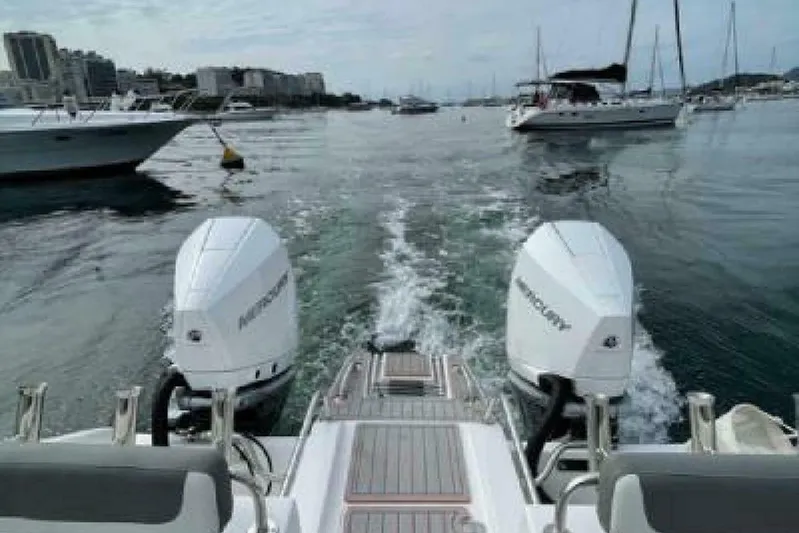  Yacht Photos Pics 2023 Garnet Offshore 300 HT boat with dual Mercury engines cruising in a marina.