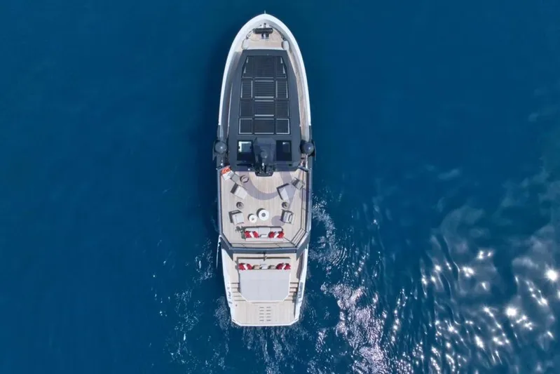 L Yacht Photos Pics Aerial view of 2024 Arcadia Yachts Sherpa 80XL cruising on blue ocean waters.