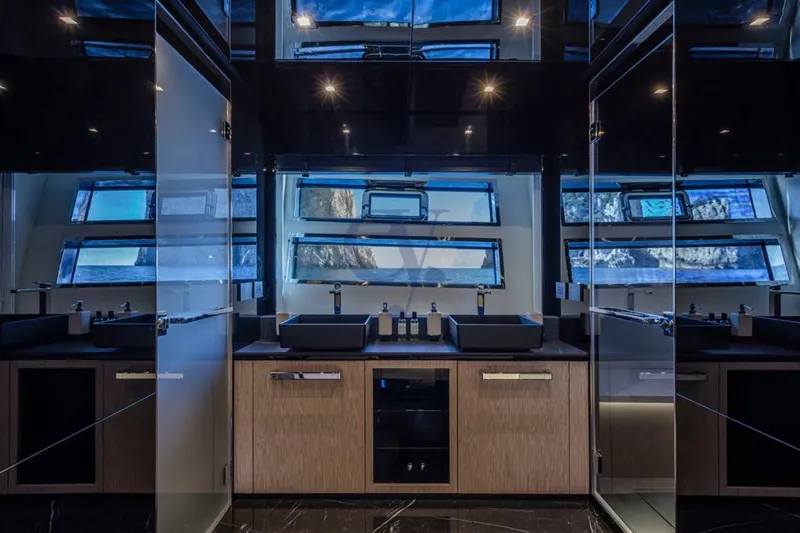 L Yacht Photos Pics Luxurious bathroom interior of 2024 Arcadia Yachts Sherpa 80XL with modern fixtures and large windows.