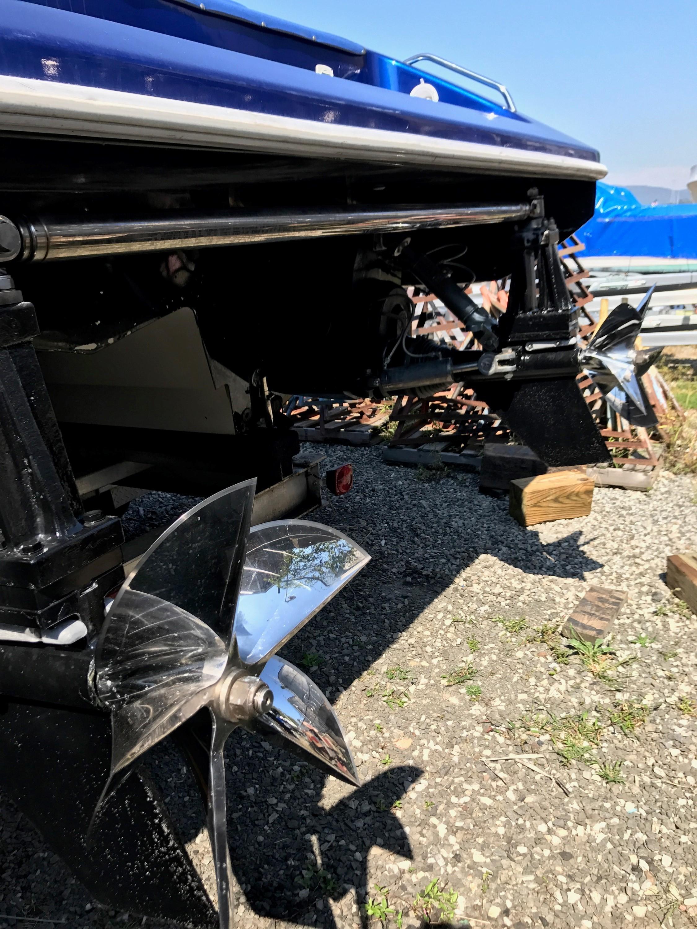 2002 Mares 38 High Performance boat with dual propellers on gravel.