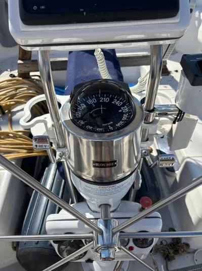 Renaissance Yacht Photos Pics Steering wheel and compass on a 2000 Catalina 380 sailboat cockpit.