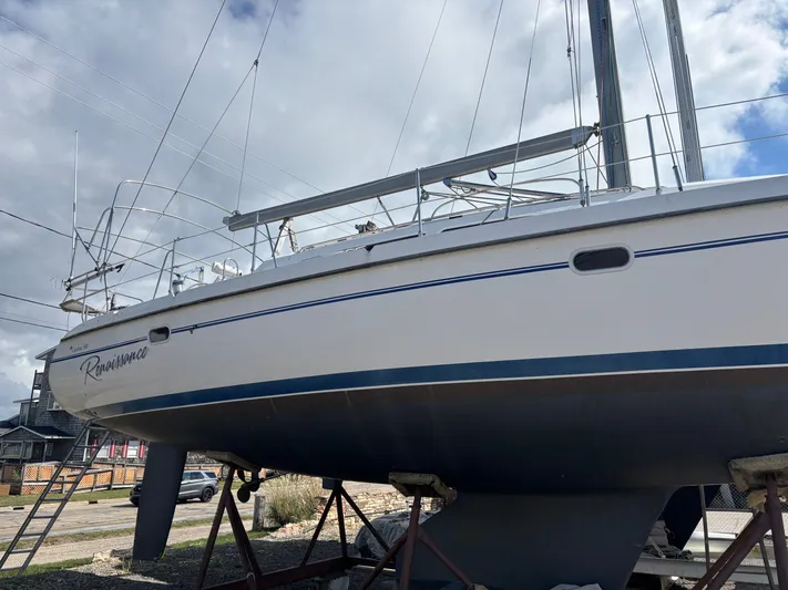 Renaissance Yacht Photos Pics Catalina 380 sailboat from 2000 on stands, under a cloudy sky.