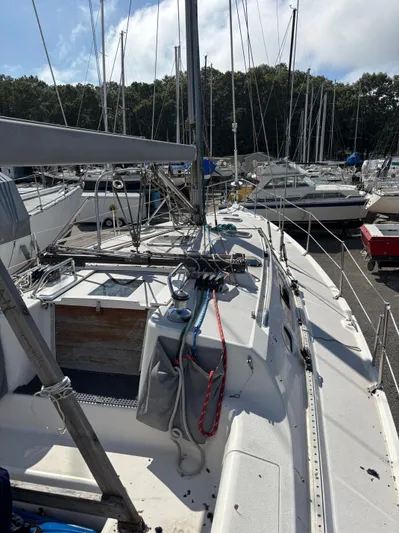 Renaissance Yacht Photos Pics Catalina 380 sailboat from 2000 docked in a marina, surrounded by other boats.