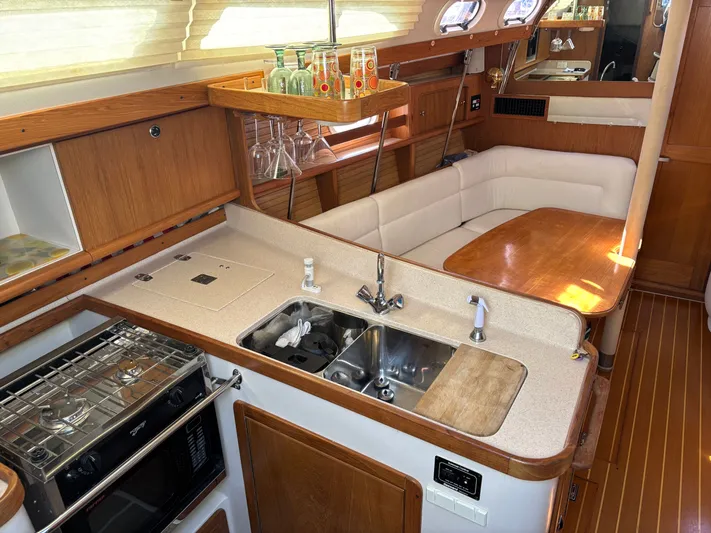 Renaissance Yacht Photos Pics Interior of 2000 Catalina 380 yacht with kitchen and dining area.