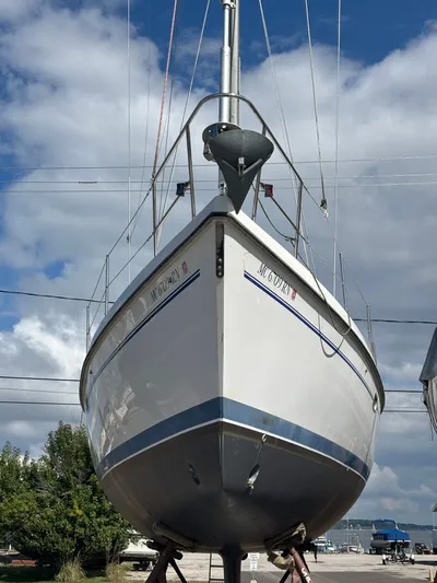 Renaissance Yacht Photos Pics Catalina 380 sailboat from 2000 on land, under a partly cloudy sky.