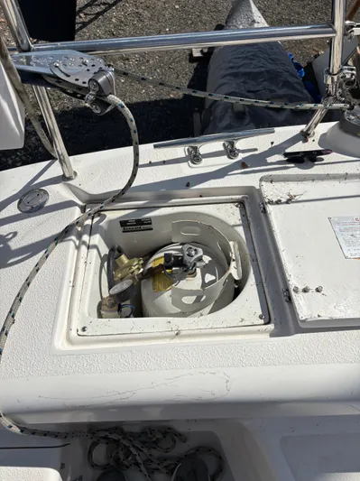 Renaissance Yacht Photos Pics Open storage compartment on a 2000 Catalina 380 sailboat deck, containing a propane tank.