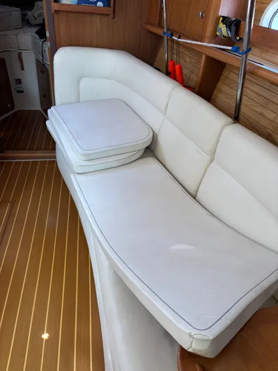 Renaissance Yacht Photos Pics White leather seating in a 2000 Catalina 380 yacht interior with wooden flooring.
