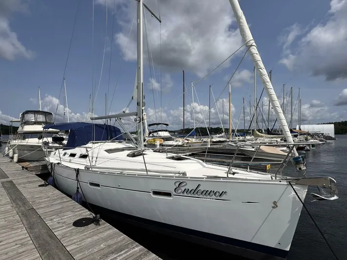  Yacht Photos Pics 2006 Beneteau 373 sailboat named Endeavor docked at a marina under a cloudy sky.