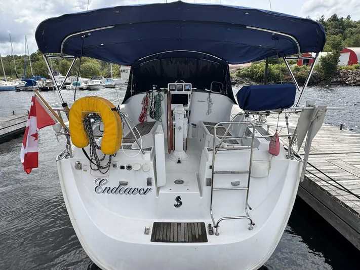  Yacht Photos Pics 2006 Beneteau 373 sailboat docked, featuring a blue canopy and Canadian flag.
