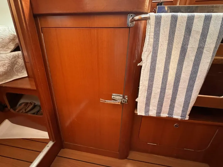  Yacht Photos Pics Interior of 2006 Beneteau 373 sailboat with wooden cabinetry and striped towel.