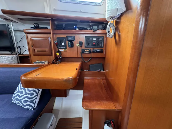  Yacht Photos Pics Interior of 2006 Beneteau 373 sailboat with navigation station and wooden cabinetry.