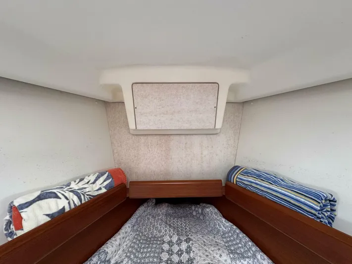  Yacht Photos Pics Cozy cabin interior of 2006 Beneteau 373 sailboat with bedding and rolled towels.