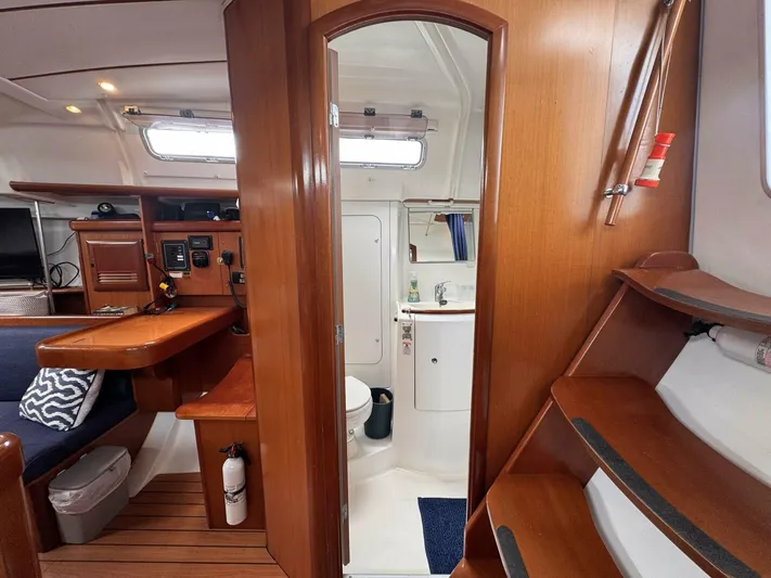  Yacht Photos Pics Interior of 2006 Beneteau 373 sailboat with wooden finishes and compact bathroom.