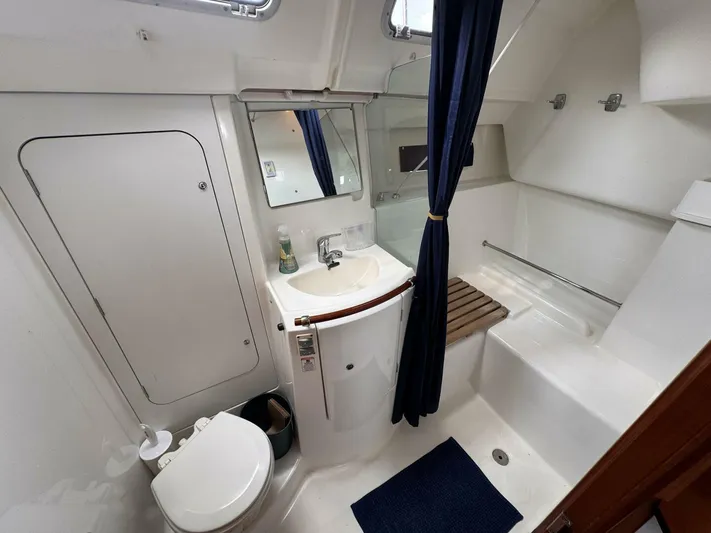  Yacht Photos Pics 2006 Beneteau 373 yacht bathroom with toilet, sink, and shower area.