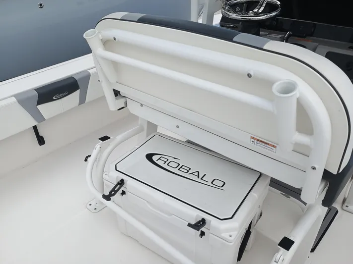 266-105 Yacht Photos Pics 2023 Robalo 266 Cayman SD boat interior with storage compartment and seating.