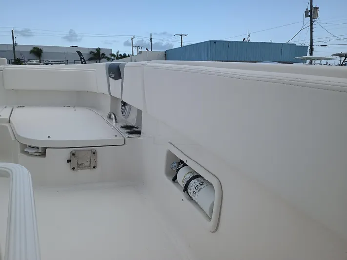 266-105 Yacht Photos Pics 2023 Robalo 266 Cayman SD boat interior with storage compartments and seating.