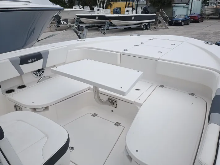 266-105 Yacht Photos Pics 2023 Robalo 266 Cayman SD boat interior with seating and table setup.