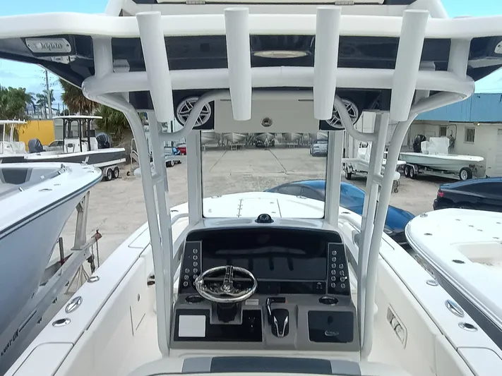 266-105 Yacht Photos Pics 2023 Robalo 266 Cayman SD boat dashboard with steering wheel and controls.