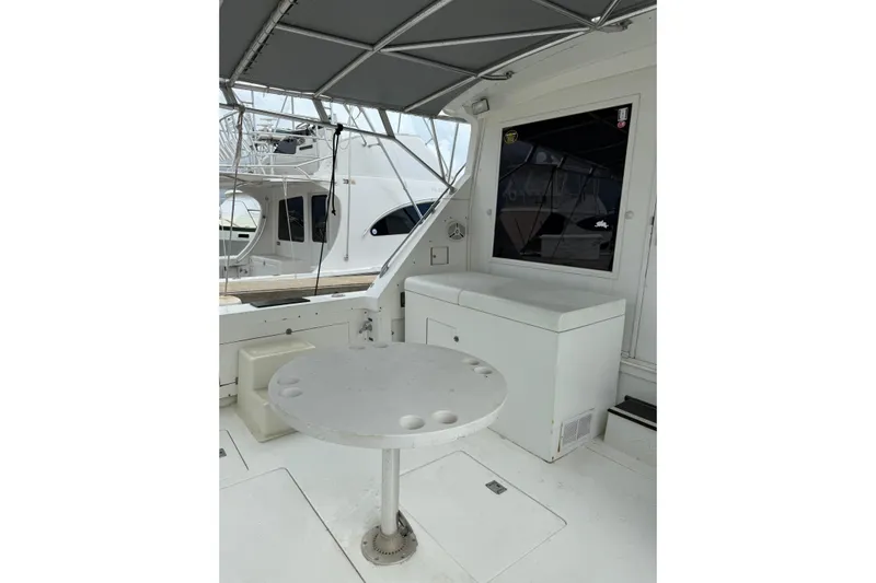 Marisabel Yacht Photos Pics 1984 Bertram 46 Convertible yacht interior with table and seating area.