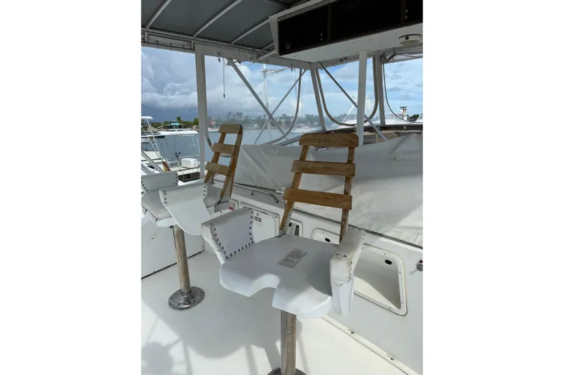 Marisabel Yacht Photos Pics Captain's chairs on 1984 Bertram 46 Convertible yacht, overlooking marina.