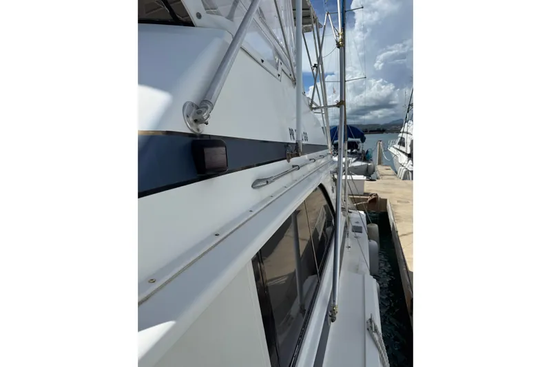 Marisabel Yacht Photos Pics 1984 Bertram 46 Convertible yacht docked at marina, side view with clear skies.