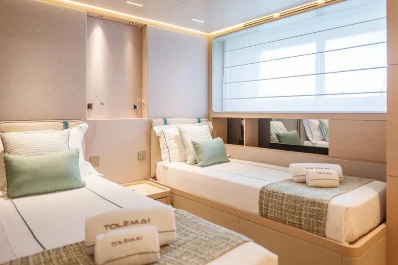 Tolemai Yacht Photos Pics Luxurious twin cabin interior of 2023 Sanlorenzo XSP202 yacht, featuring elegant bedding and soft lighting.