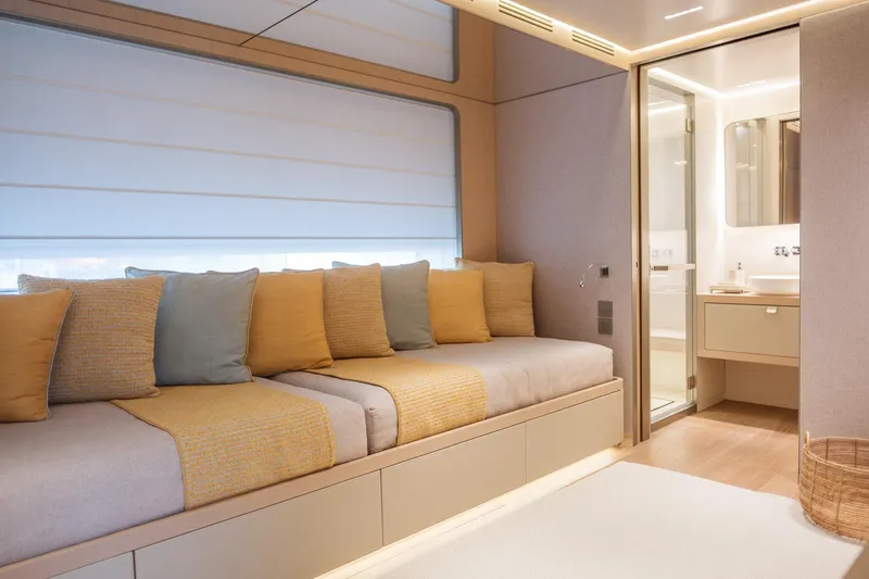 Tolemai Yacht Photos Pics Luxurious interior of 2023 Sanlorenzo XSP202 yacht with cozy seating and modern bathroom.