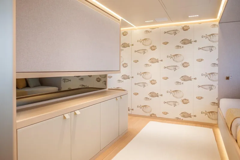 Tolemai Yacht Photos Pics Luxurious Sanlorenzo XSP202 yacht interior with fish-patterned wall, modern cabinetry, and ambient lighting, 2023 model.