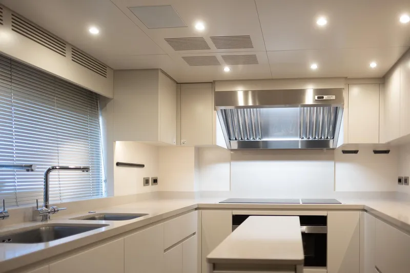 Tolemai Yacht Photos Pics Modern kitchen interior on 2023 Sanlorenzo XSP202 yacht, featuring sleek design and stainless steel appliances.