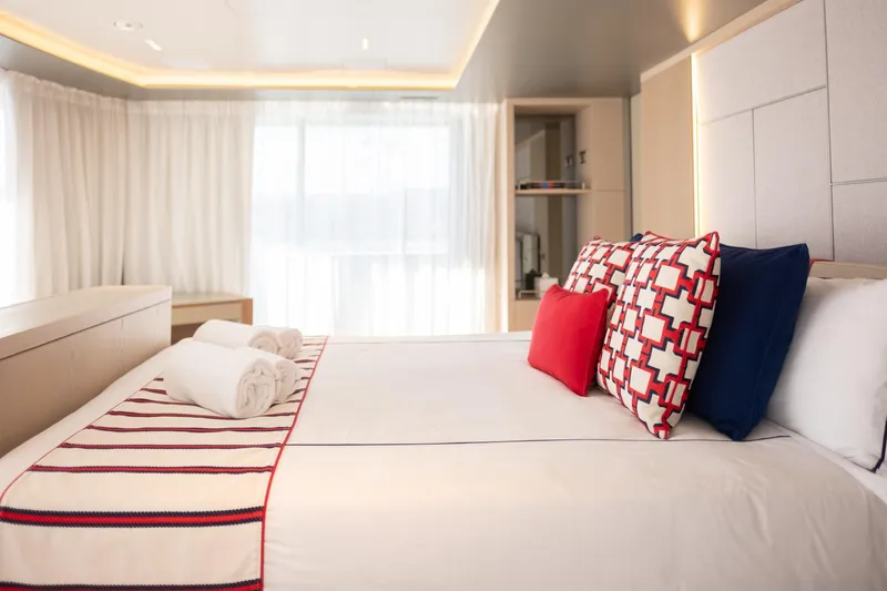 Tolemai Yacht Photos Pics Luxurious Sanlorenzo XSP202 yacht bedroom, 2023 model, with elegant decor and plush pillows.