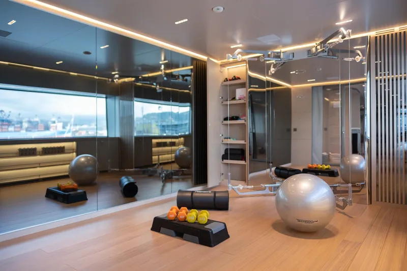 Tolemai Yacht Photos Pics Luxurious gym on Sanlorenzo XSP202 yacht, featuring modern equipment and sleek design, 2023 model.