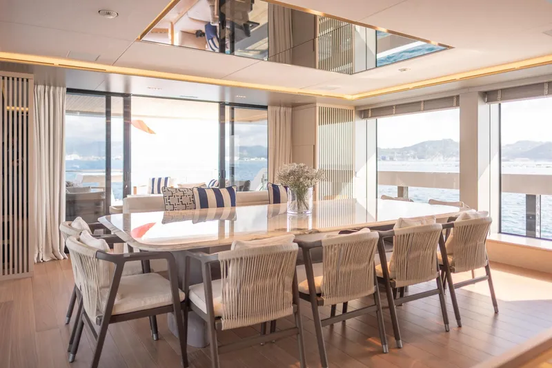 Tolemai Yacht Photos Pics Luxurious dining area on 2023 Sanlorenzo XSP202 yacht with ocean views and elegant decor.